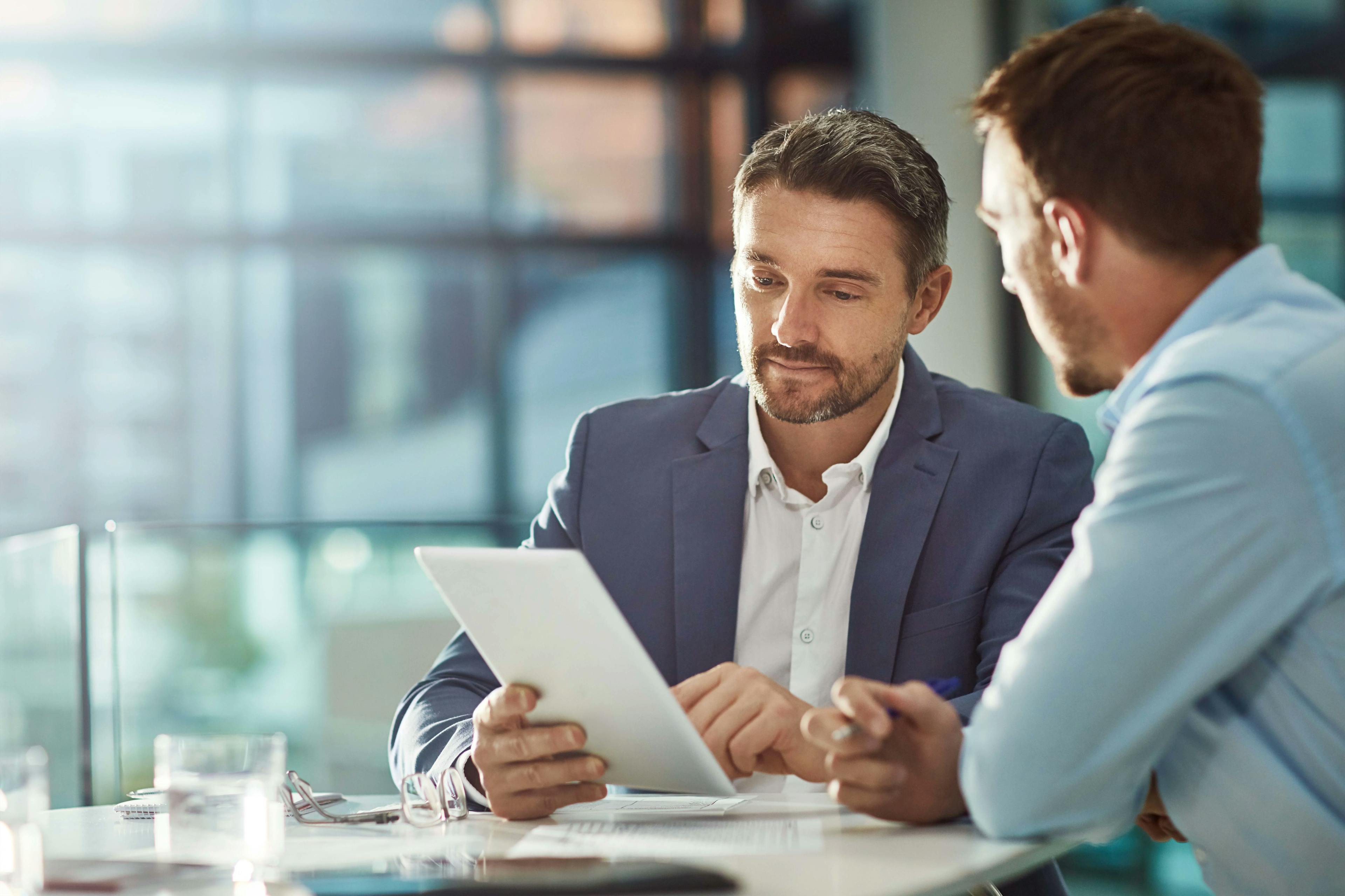 Two executives looking at a document