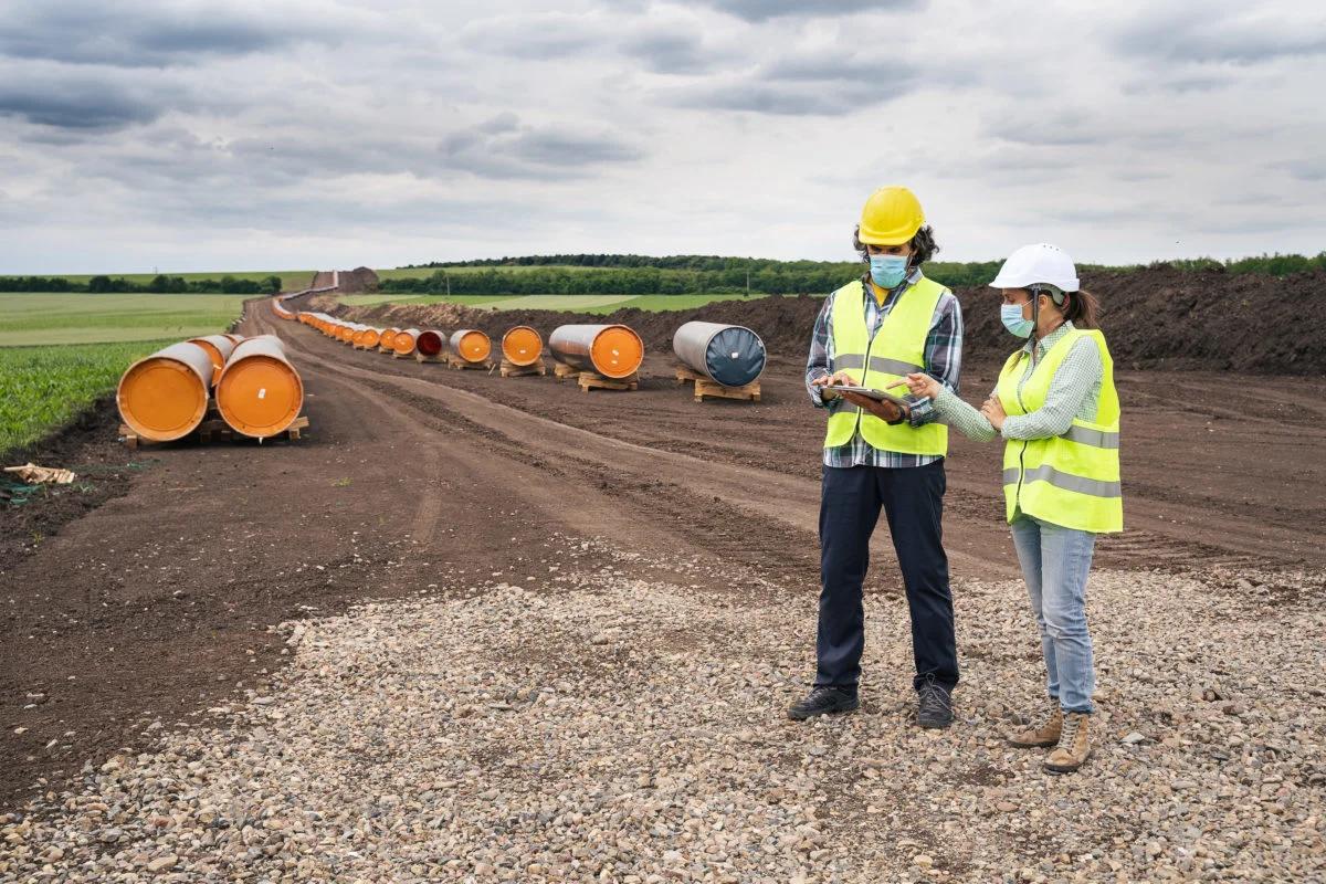 Two construction workers in a field 1200x800