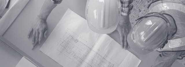 Over head shot of two construction workers looking at a drawing