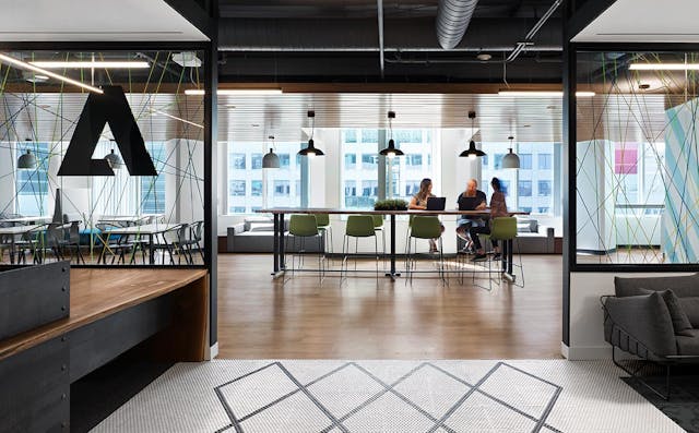 MARANT Adobe Systems Inc Canada - three employees talking at a desk in the distance
