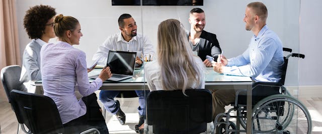 Employees talking at a table