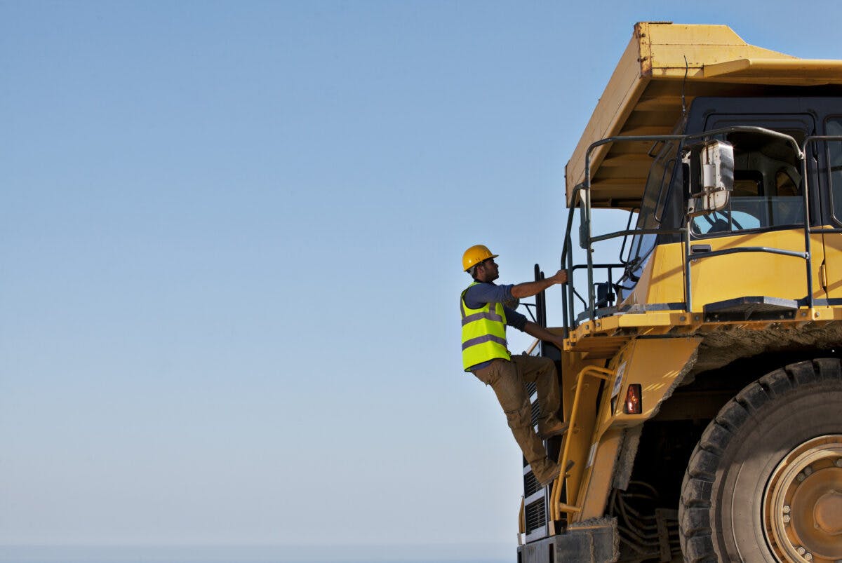 Construction worker on a large dump truck