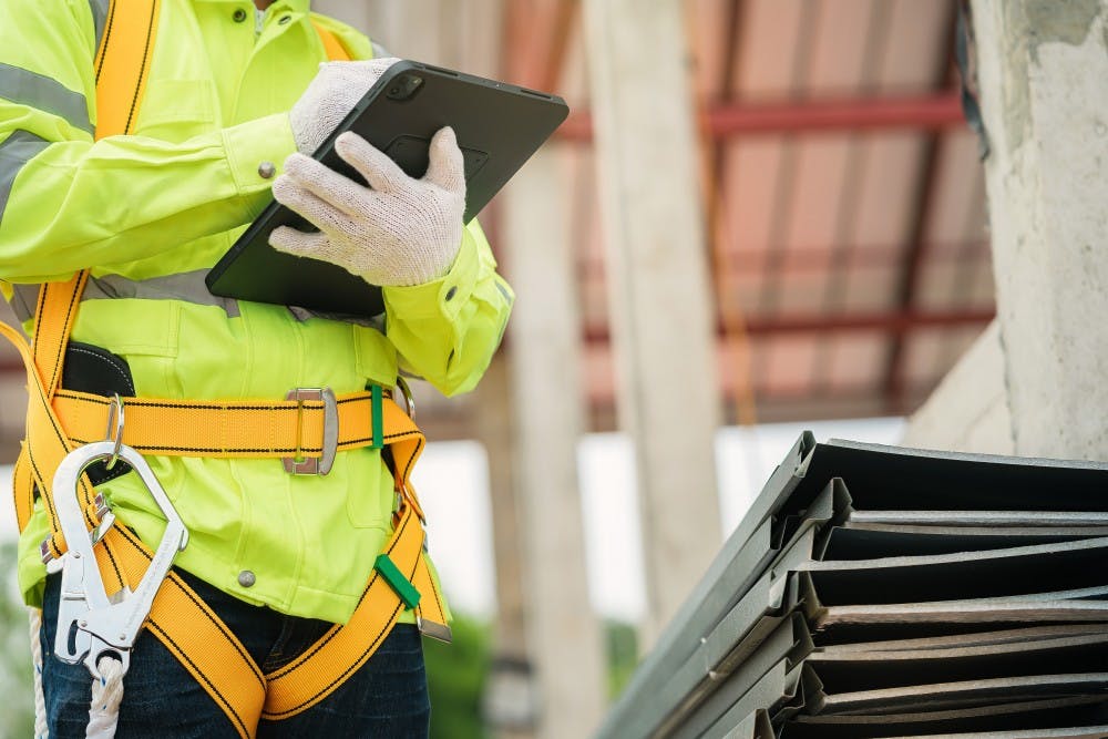 Construction worker looking at an iPad